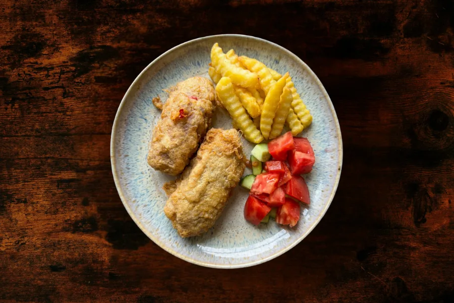 Börek-style peppers served with french fries, tomatoes, and cucumbers.