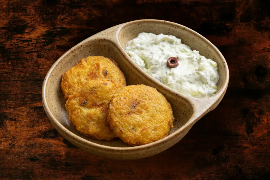 3 potato patties with a side dish